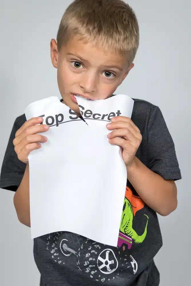 kids eating papers with curiosity